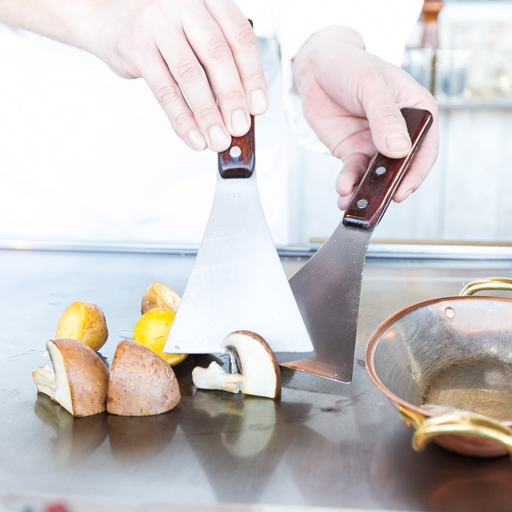 Mit den Spachteln werden Zutaten am Teppan zerkleinert.